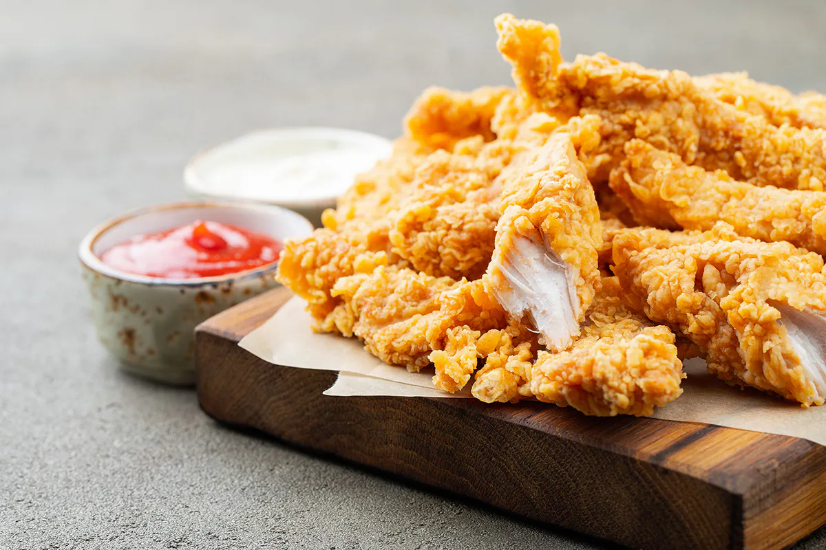 Crispy fried chicken tenders served with dipping sauces