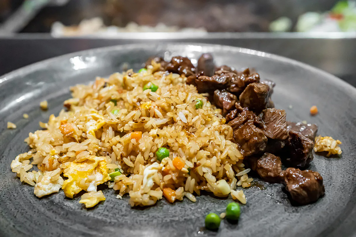 A Plate of Hibachi Vegetable Fried Rice with Chicken and Steak